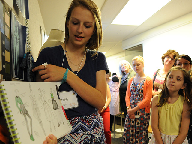 Girl showing her fashion designs
